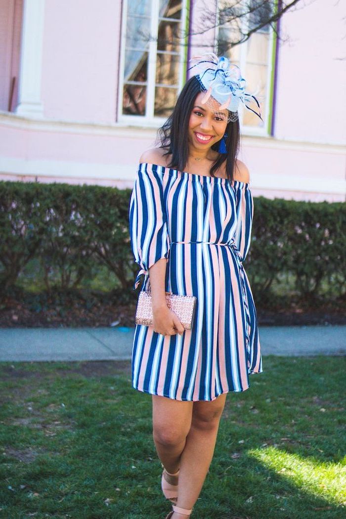 brunette woman with a hat on her head, wearing blue white and pink striped dress, flowy dresses, pink heels