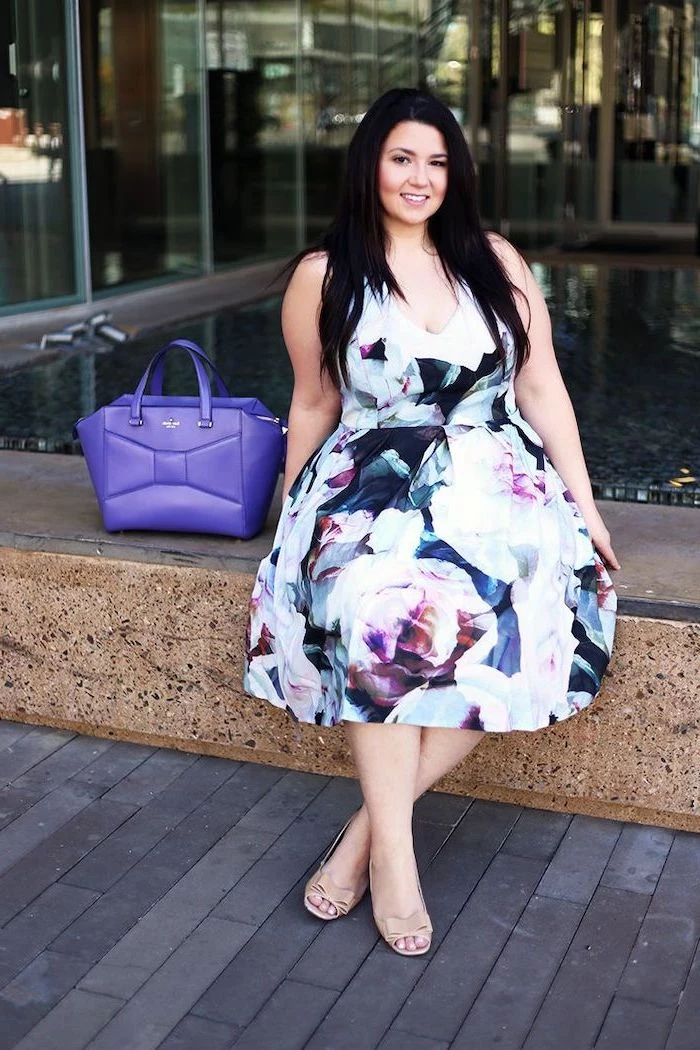 woman with long black hair, wearing a dress with floral print, flowy dresses, purple leather bag next to her