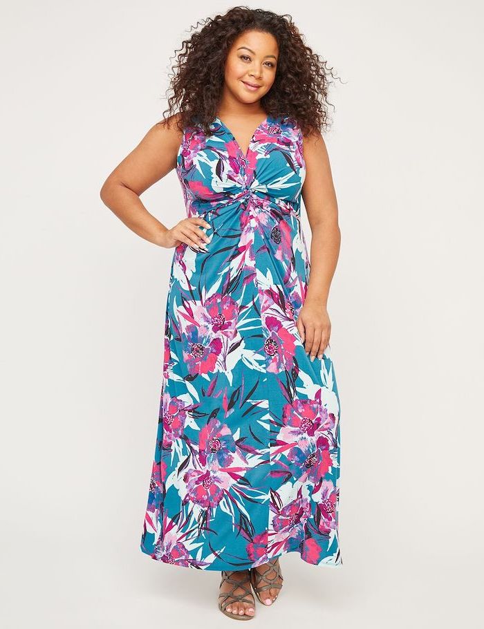 woman with brown curly hair, wearing a long blue dress with floral print, sunflower dress, nude sandals