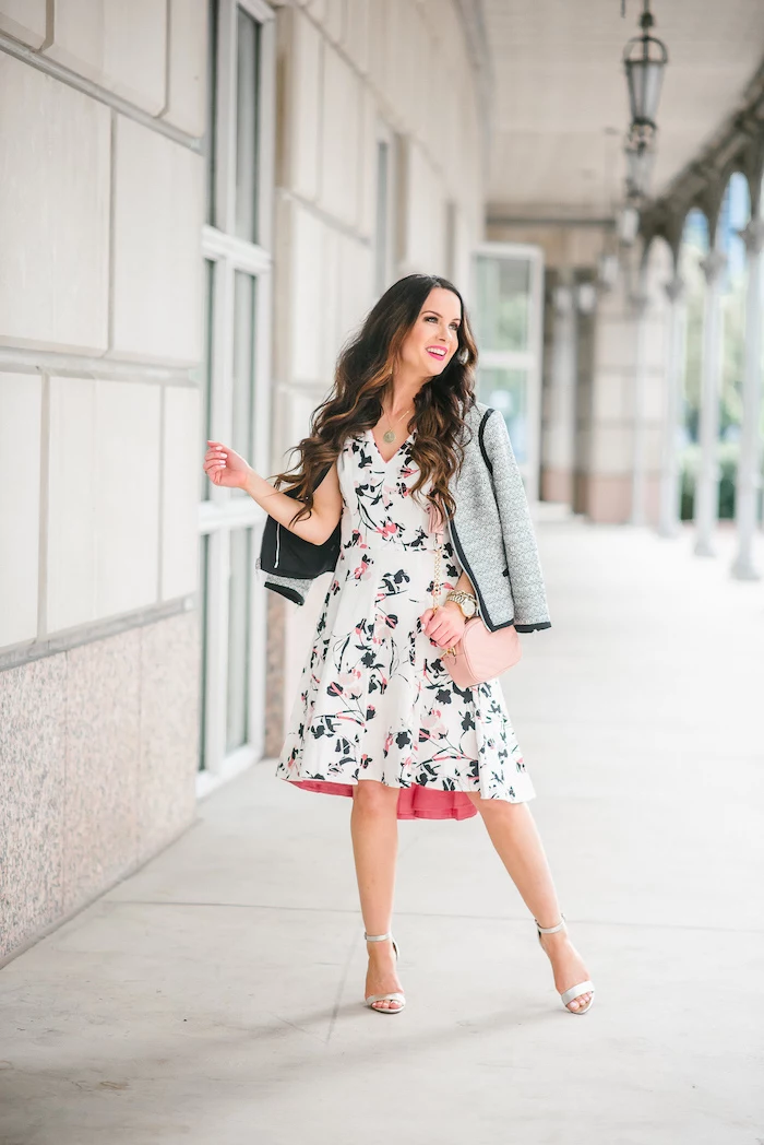 woman with brown long wavy hair, wearing white dress with floral print, grey blazer, easter outfits