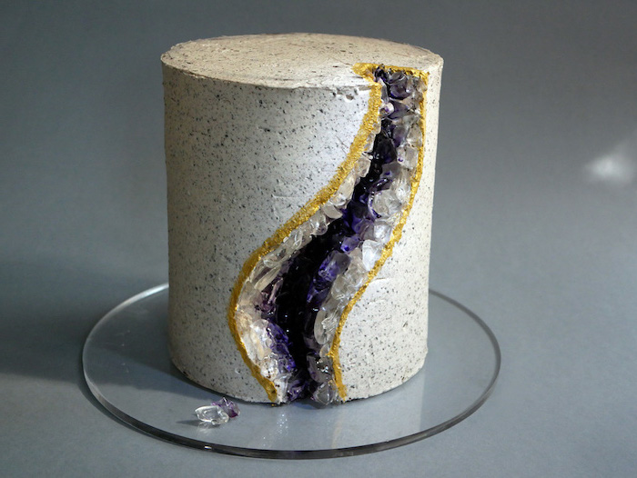 geode wedding cake, one tier cake, covered with buttercream, decorated with purple and white rock candy, placed on glass cake tray