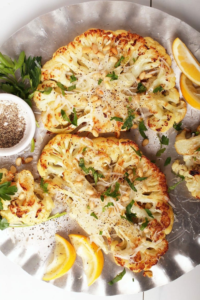 roasted cauliflower, cheese and parsley garnish on top, easter lunch ideas, lemon slices on the side