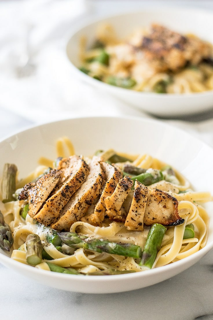 what to cook for dinner tonight easy, chicken and asparagus pasta, chicken breast sliced, placed on top of pasta