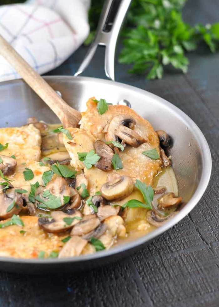 chicken marsala with mushrooms, easy dinner recipes for beginners, cooked in sauce pan wih wooden spoon