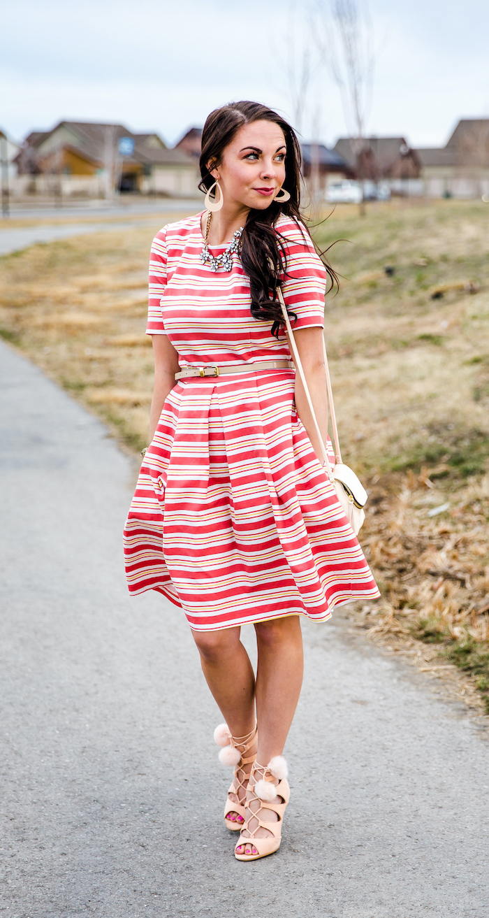 woman with brown wavy hair, wearing white and red striped dress, easter outfit, nude heels