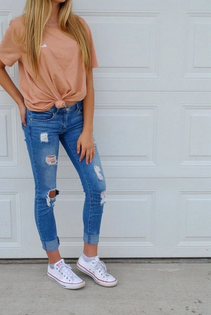 back to school outfits, blonde woman wearing jeans, blush pink t shirt, white low top converse shoes