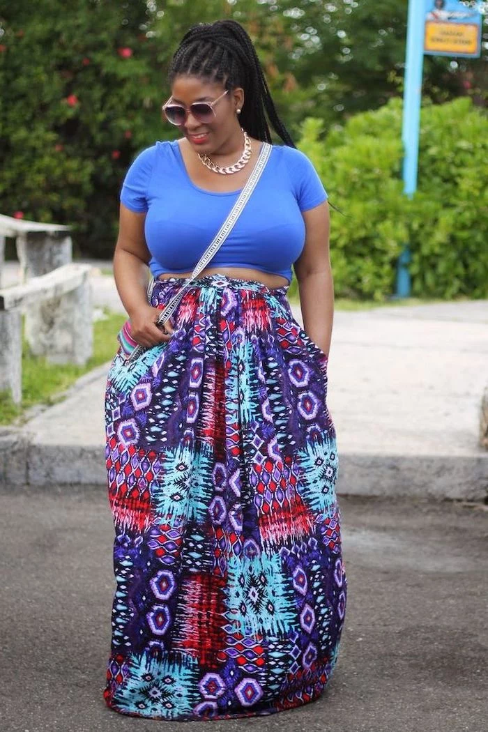 woman with black braided hair, wearing blue top and long skirt with colorful print, easter outfit