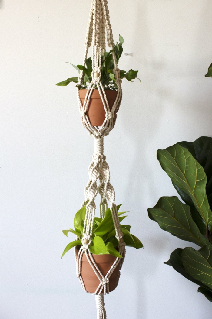 double plant hanger with two ceramic pots, how to make a hanging planter, white wall in the background