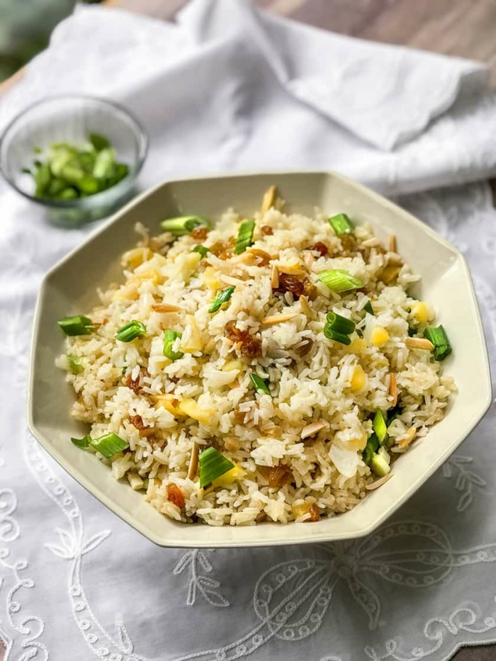 rice pilaf in white hexagonal plate, placed on white table runner, easter dinner ideas