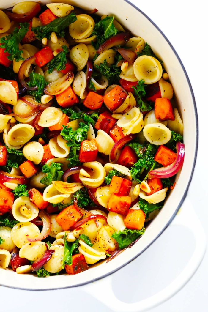 pasta with caramelized sweet potatoes, kale and onion, good home cooked meals, cooked in white skillet