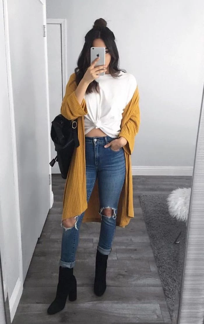 brunette woman wearing jeans and white t shirt, yellow mustard cardigan, cute comfy outfits, black velvet boots