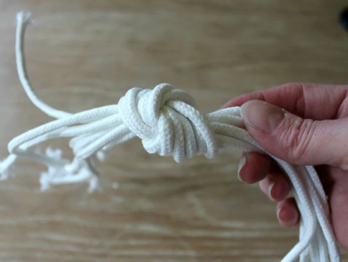 few strands of macrame tied together, step by step diy tutorial, macrame plant hanger diy