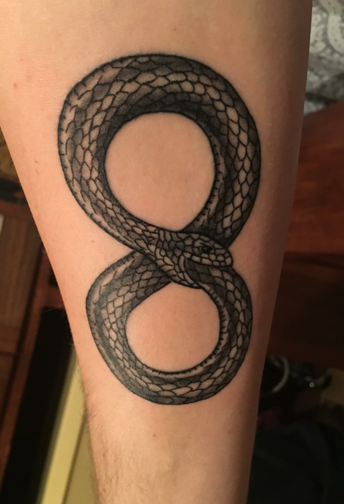 snake as an infinity symbol, snake eating its tail, forearm tattoo