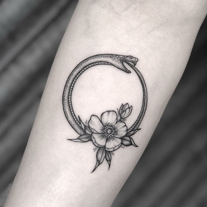 flower and a snake, forearm tattoo, snake eating itself, black and white photo