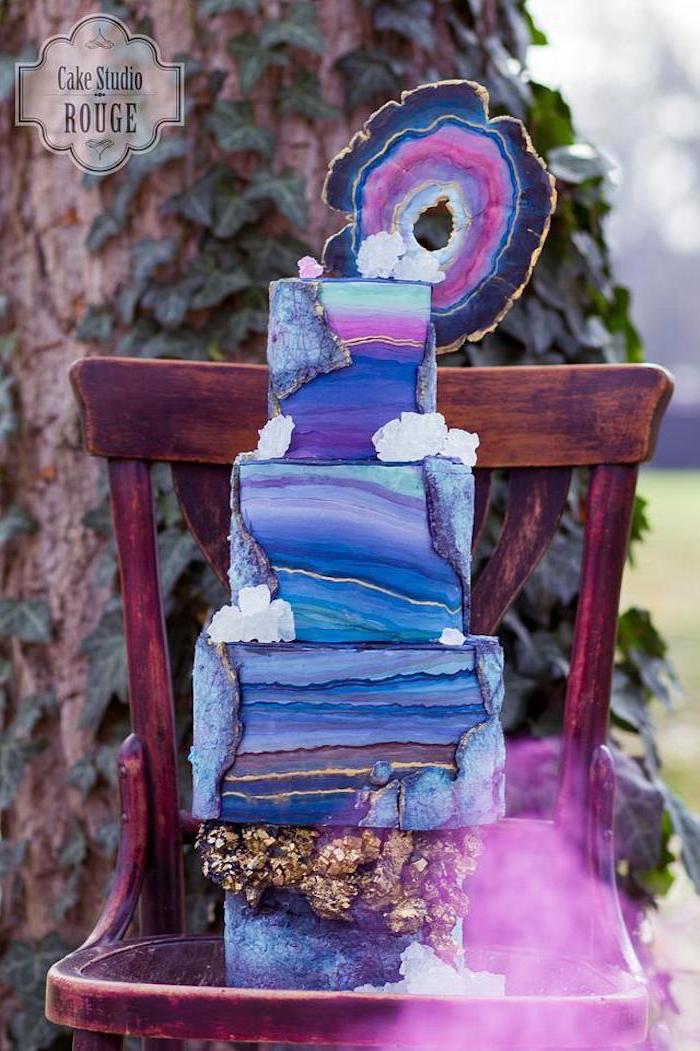 four tier cake, covered with colorful galaxy fondant, geode cupcakes, decorated with galaxy painted rock candy