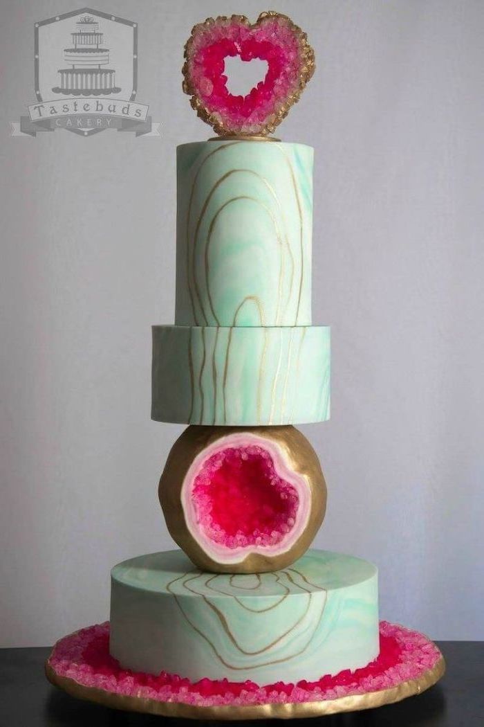 how to make a geode cake, four tier cake, covered with green and gold marble fondant, decorated with pink rock candy