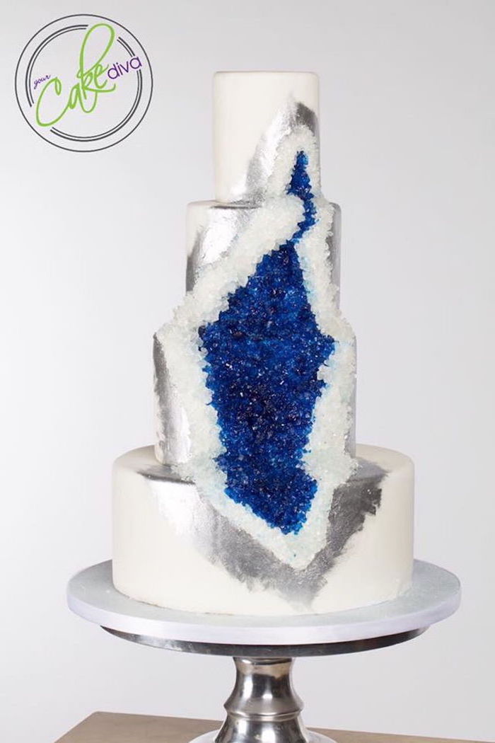 four tier cake, covered with white fondant, decorated with white and blue rock candy, how to make a geode cake, silver paint