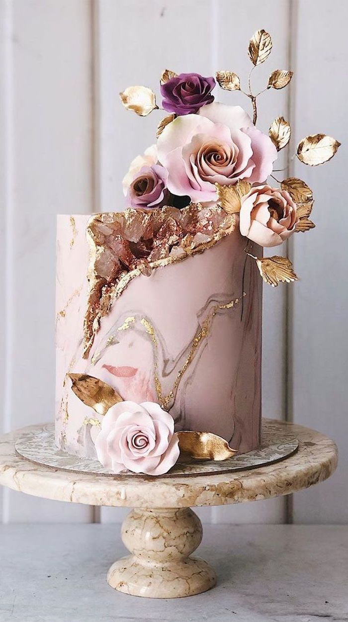 one tier cake, covered with pink and gold marble fondant, rock candy cake, decorated with pink rock candy and flowers