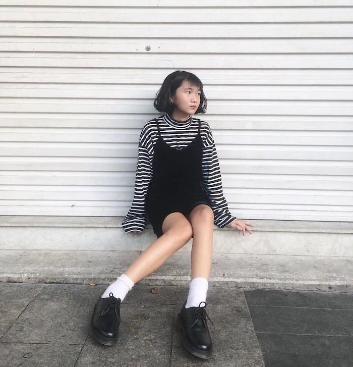 girl sitting on a step, wearing black dress, white and black blouse underneath, fall outfits for girls, black shoes with white socks
