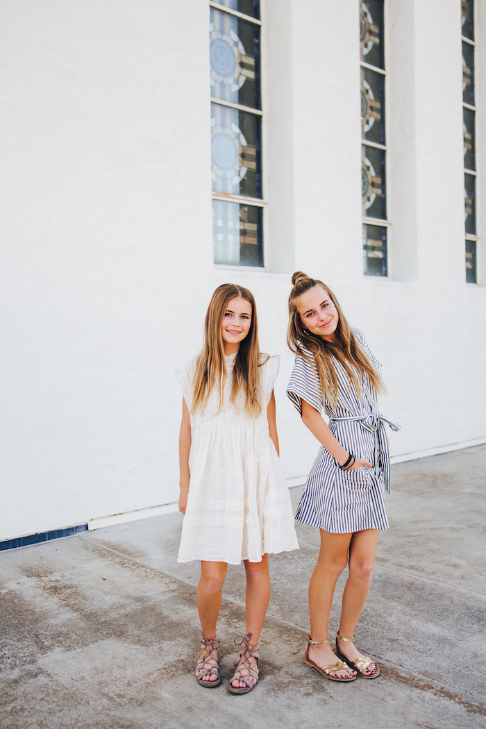 two girl with blonde hair, standing on a sidewalk, wearing dresses, nude sandals, plus size easter dresses