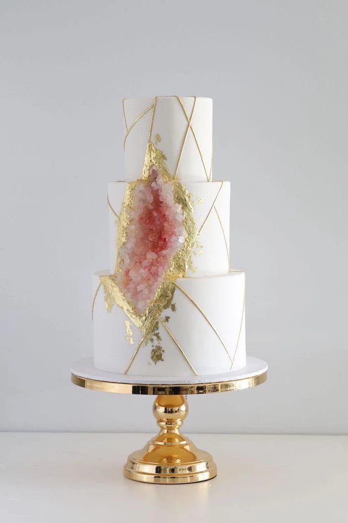 three tier cake, covered with white fondant, rock candy cake, decorated with white and pink rock candy