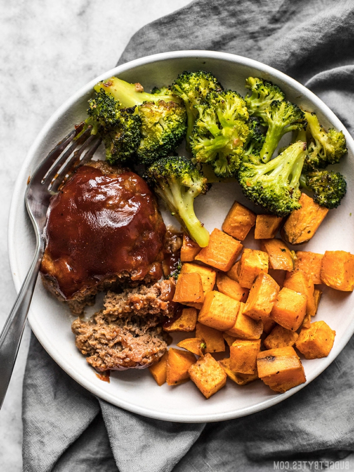 stealk with broccoli and sweet potatoes, quick and easy dinner recipes, placed on white plate with fork on the side