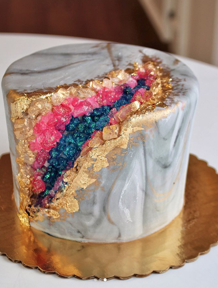 amethyst cake, one tier cake, covered with grey and white marble cake, decorated with blue pink and gold rock candy