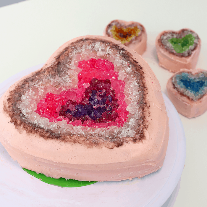 heart shaped mini cakes, covered with pink buttercream, amethyst cake, decorated with white pink and purple rock candy