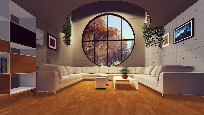 large living room with large white sofa, laminate flooring, wooden floor and large round window, white coffee table and ottomans