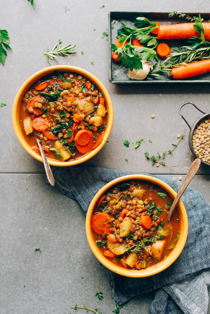 lentil sop with carrots and potatoes, poured in two ceramic bowls, quick and easy dinner recipes, placed on grey table