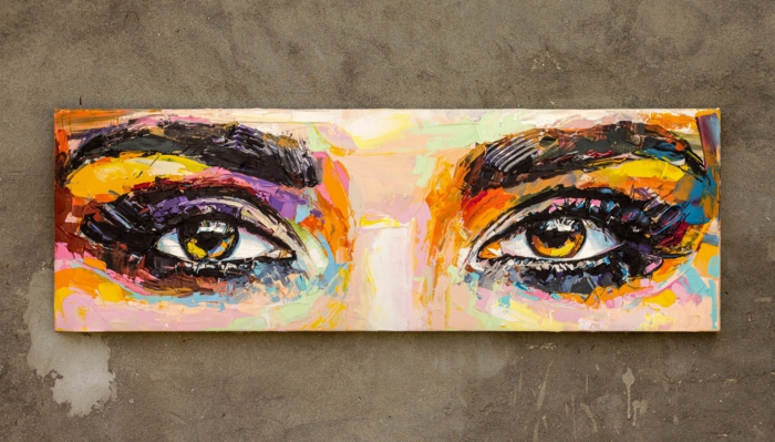 cool eye drawings, painting of a set of female eyes, thick eyebrows above them, hanging on a grey wall