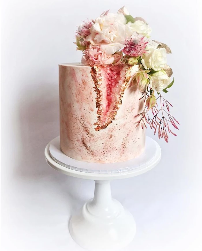 marble geode cake, one tier cake, covered with pink and white marble fondant, decorated with pink rock candy and flowers