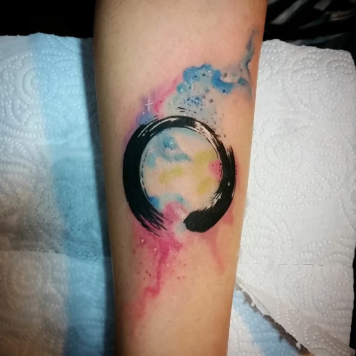watercolor forearm tattoo, hand leaning on white paper towels, ouroboros meaning, galaxy sky in different colors