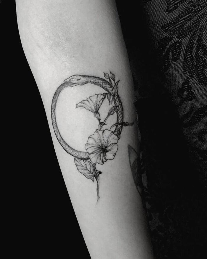 forearm tattoo, snake with flowers underneath, ouroboros symbol, black and white photo