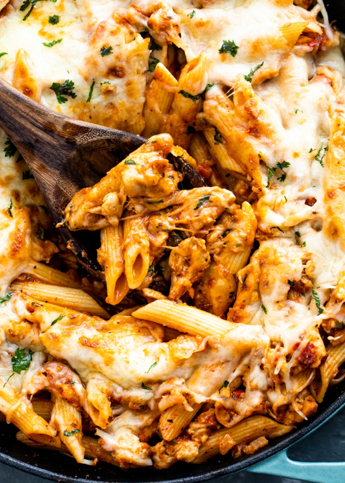pasta with chicken parmesan, easy dinners for two, covered with cheese, garnished with parsley
