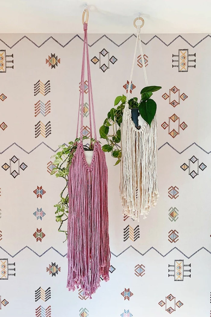 pink and white tassel hangers, hanging from the ceiling, wall with patterns in the background, 5 minute macrame plant hanger