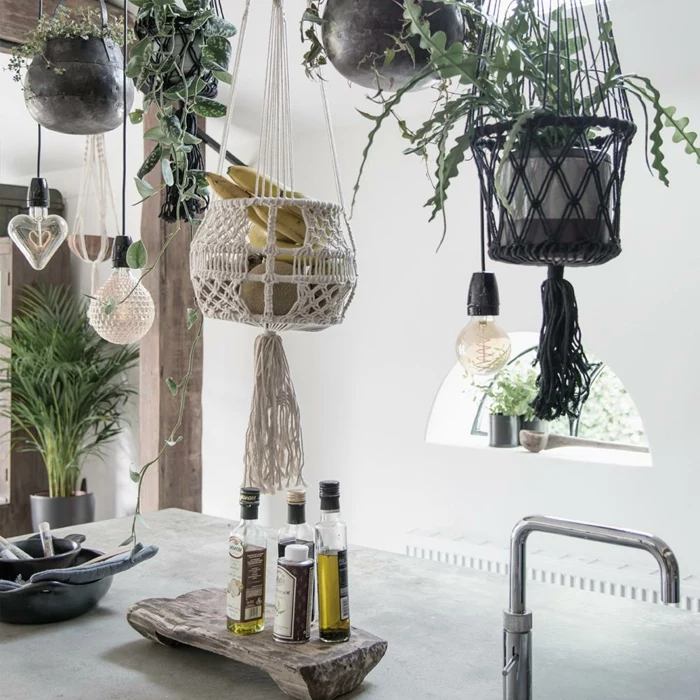 different plants hanging above a kitchen island, 5 minute macrame plant hanger, oil and vinegar bottle on top