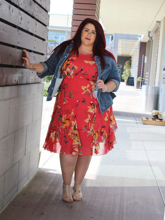 woman with red hair, wearing a pink dress with floral print, pretty dresses for women, denim jacket on top