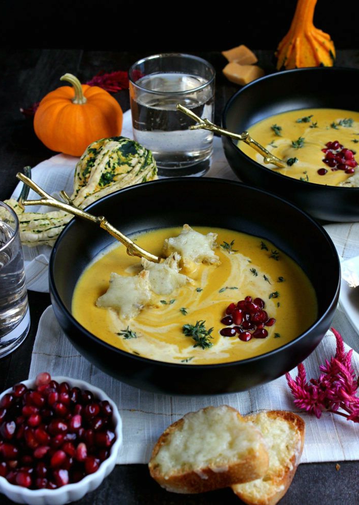 butternut squash soup, poured in black bowls, dinner ideas for tonight, garnished with pomegranate seeds