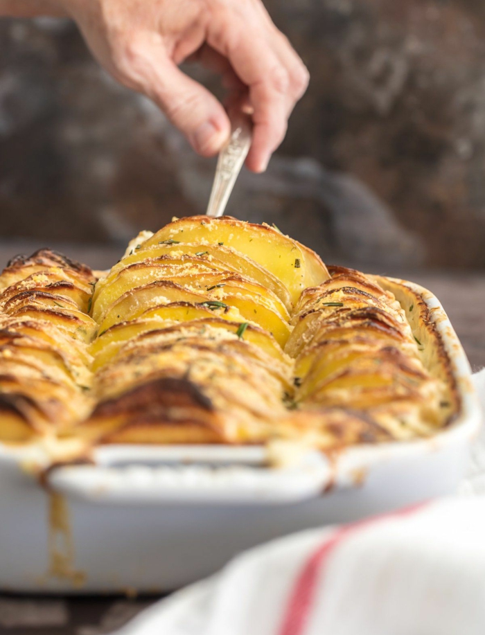 garlic and herb scalloped potatoes, easter dinner ideas, sliced and arranged in white casserole dish