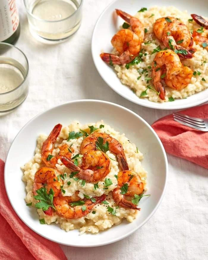 shrimp risotto, easy dinner ideas for two, garnished with parslye, placed in white plates