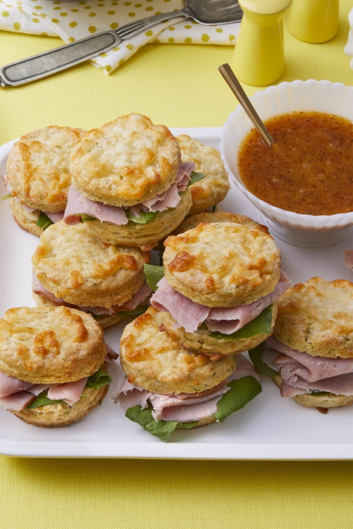 small sandwiches made with biscuits, easter ham dinner, spinach and ham inside, arranged on white plate