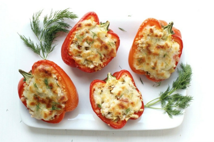 stuffed bell peppers, cut in half, filled with quinoa and cheese, garnished with dill, easy weeknight dinners