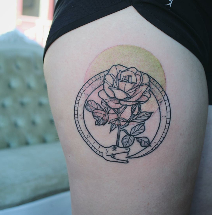 rose surrounded by a snake, red and yellow circle, thigh tattoo, serpent eating its own tail