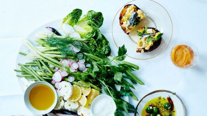 white plate full of different green vegetables, easter dinner menu ideas, turnip cauliflower and lemon slices
