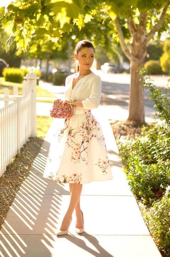 woman with brown hair in ponytail, wearing a white shirt, white skirt with floral print, cute spring dresses