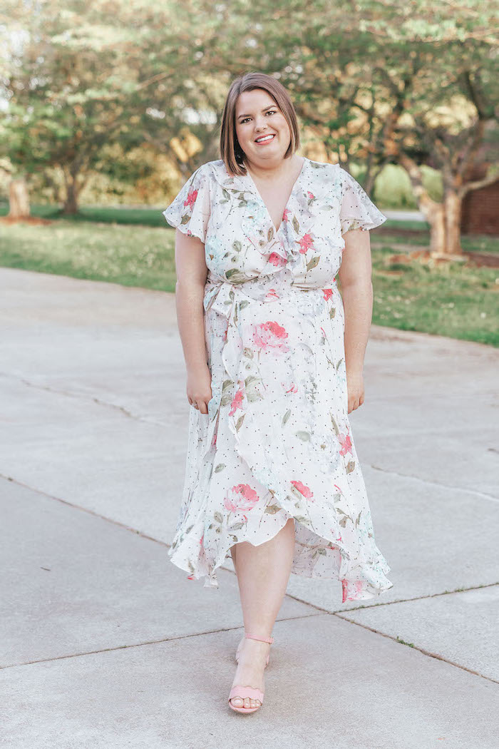 woman with short brown hair, sunflower dress womens, wearing a white wrap dress with floral print, nude heels