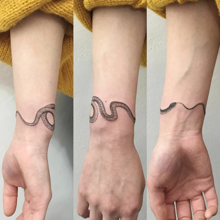 snake wrapped around the wrist, wrist tattoo, snake eating itself tattoo, woman wearing yellow sweater