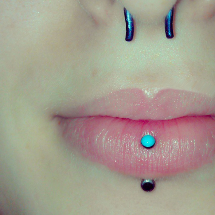 close up photo, lips with clear lip gloss, bottom lip piercing, septum piercing