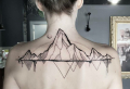 Showcase your adventurous spirit with a mountain range tattoo